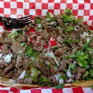 5 mini asada tacos with onions and cilantro.