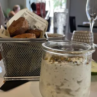 a jar of yogurt and a basket of bread