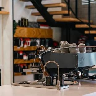 a man standing behind a coffee machine