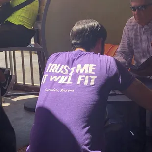 Waiter wearing great shirt!