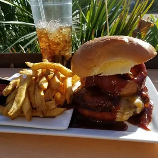 Burger topped with cheese, onion rings, and bbq sauce