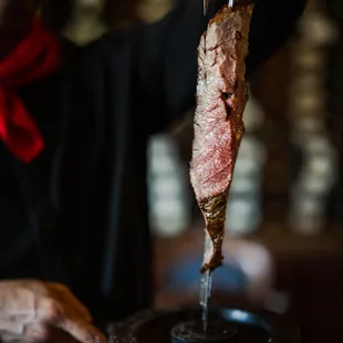 a man holding a piece of meat