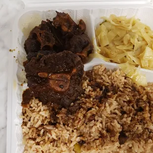 Oxtails, cabbage, rice and peas.