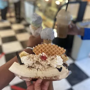 a hand holding a waffle sundae
