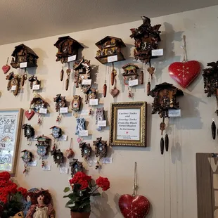 a wall of cuckoo clocks