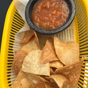 a basket of chips and salsa