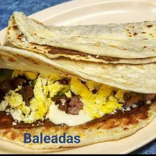 a plate of breakfast tacos