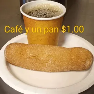 a plate with a sandwich and a cup of coffee