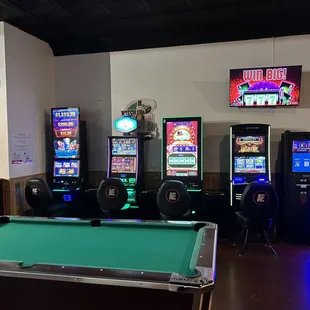 a pool table and arcade machines