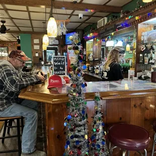 a man and woman sitting at the bar