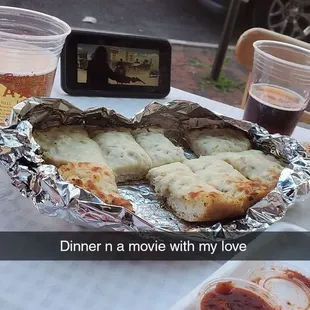 a plate of pizza and a glass of beer