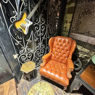a leather chair and a guitar