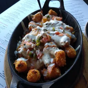 Southwest tots - smothered with cheese, green chili, pico de Gallo