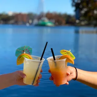 two people toasting drinks