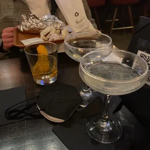 two glasses of alcohol on a table