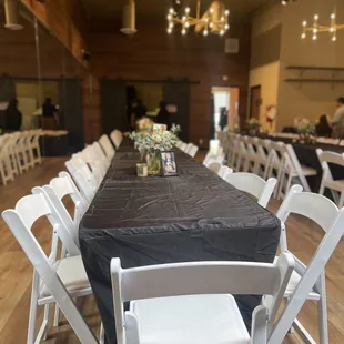 8ft tables and white padded chairs