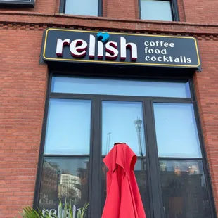 a red umbrella outside a coffee shop