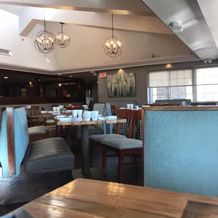 a view of a dining room with tables and chairs