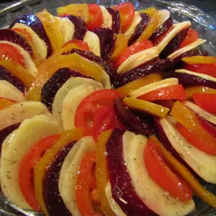 My Vegetable Tian (Tian means Heaven).  Roasted Red &amp; Gold Beets, Yukon Golds, Campari Tomato, atop slices of Vidalia Onions, b4 roasting.