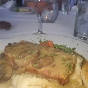 Meatloaf with cremini mushroom gravy, mashed potatoes and peas and carrots. In the background, my Strawberry Passion