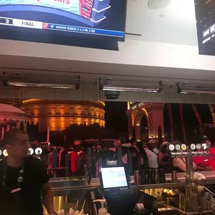 a man standing in front of a bar