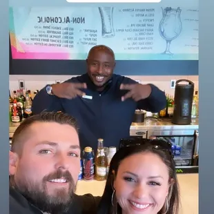 a man and a woman standing in front of a bar