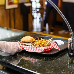  a man serving a burger and fries