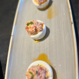 three deviled eggs on a plate