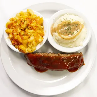 a plate of food with meat, macaroni and cheese