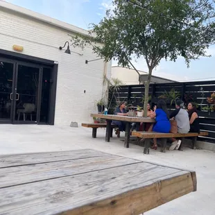 people sitting at picnic tables