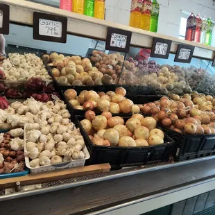a display of onions and garlic