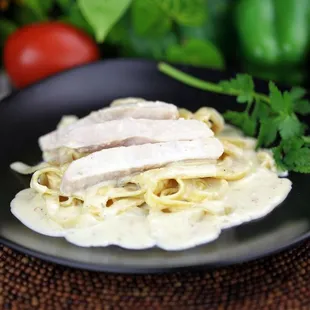 a plate of pasta with chicken