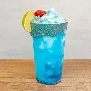 a blue drink in a tall glass