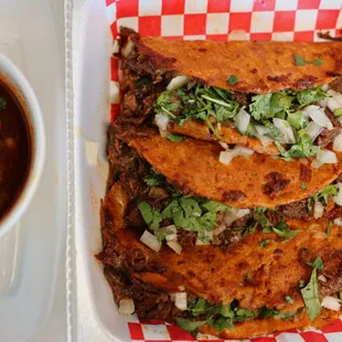 a plate of tacos and a bowl of salsa