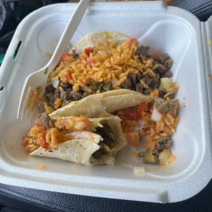 Carne Asada tacos with rice and spicy salsa on top