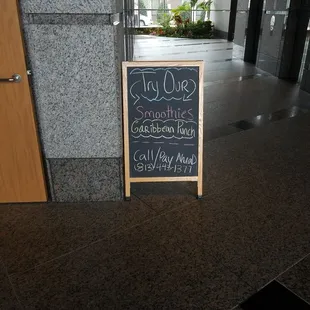 a blackboard sign in front of a building