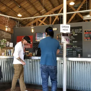 two men standing at the bar