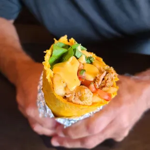 a person holding a burrito