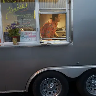 a man in the window of a food truck