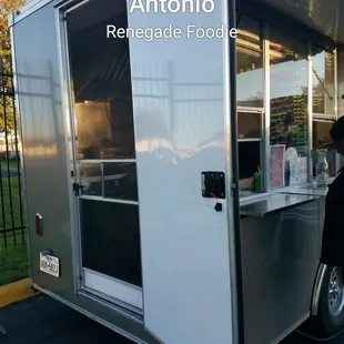 a man standing in front of a food truck
