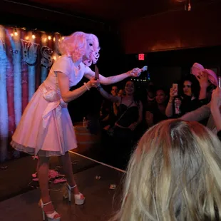 a woman dressed in a pink dress and high heels