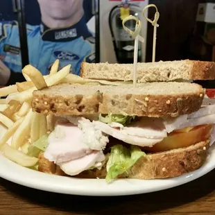 Turkey sandwich with fries  on wheat bread