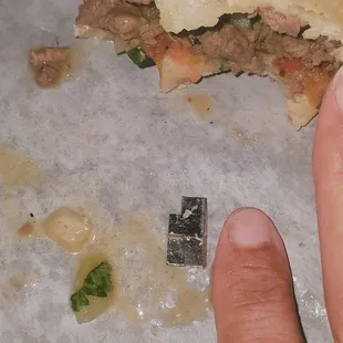 a hand holding a piece of food