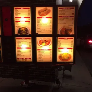 a menu on the side of a building