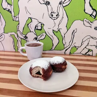 a plate of doughnuts and a cup of coffee