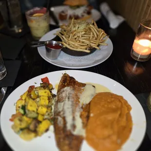 Trout Amandine, roasted veggies, and sweet potatoes mash. Truffles fries in the background.