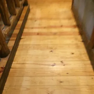 a wood floor with a wooden railing