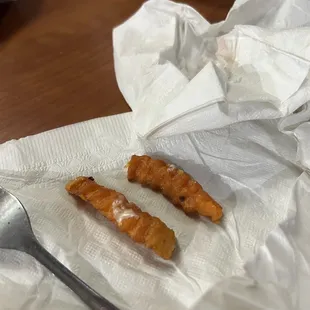 a fork and some croissants on a napkin