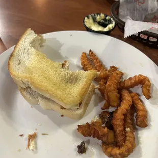 a half eaten sandwich and fried worms