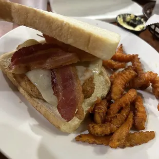 a bacon and cheese sandwich with fried chicken